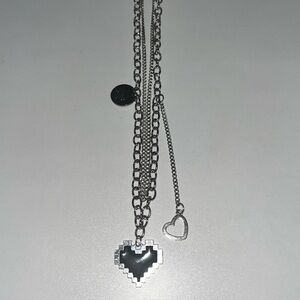 Medium size, silver necklace chain with black heart, pendant, and other charms
